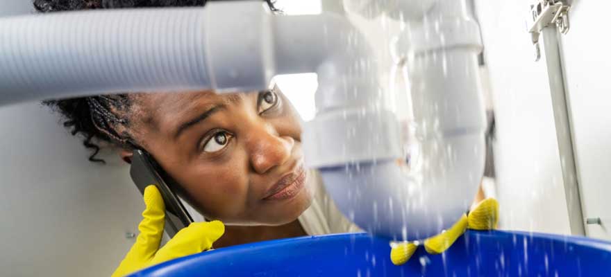 Professional plumber repairing a burst pipe during an emergency service in Lawrenceville, GA.