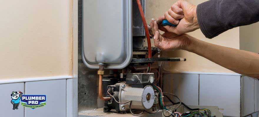 Licensed Gwinnett Plumber Pro technician performing a water heater installation in a Rest Haven, GA home. The plumber is using tools to secure the water heater in place, ensuring safe and efficient operation.