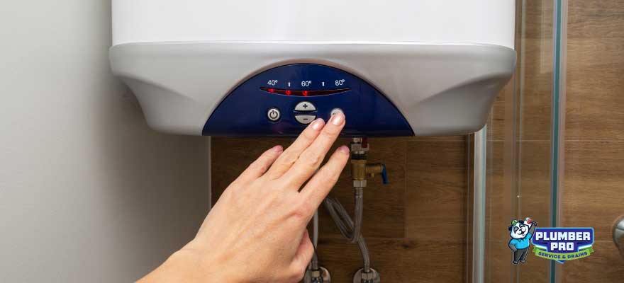 Professional plumber installing a tankless water heater in a modern home in Lawrenceville, GA. The plumber is using tools to mount the water heater and ensure proper installation.