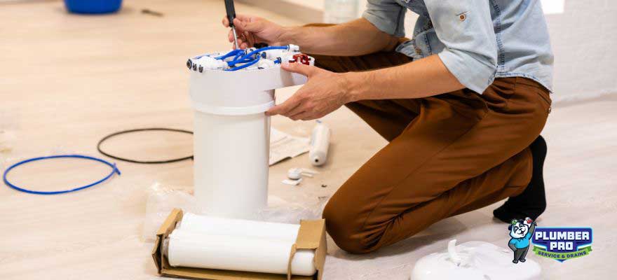 Gwinnett Plumber Pro technician installing a whole-house water purification system in a Lawrenceville, GA home, ensuring clean and safe water for the entire household.